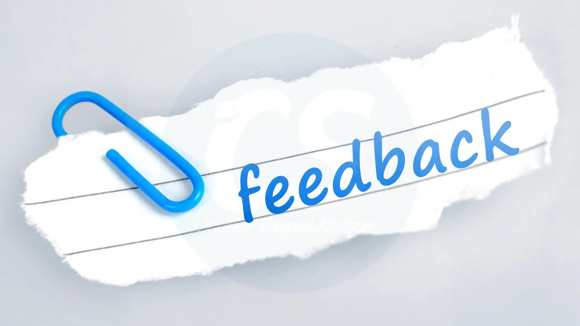 feedback written on a white paper with a blue pin.